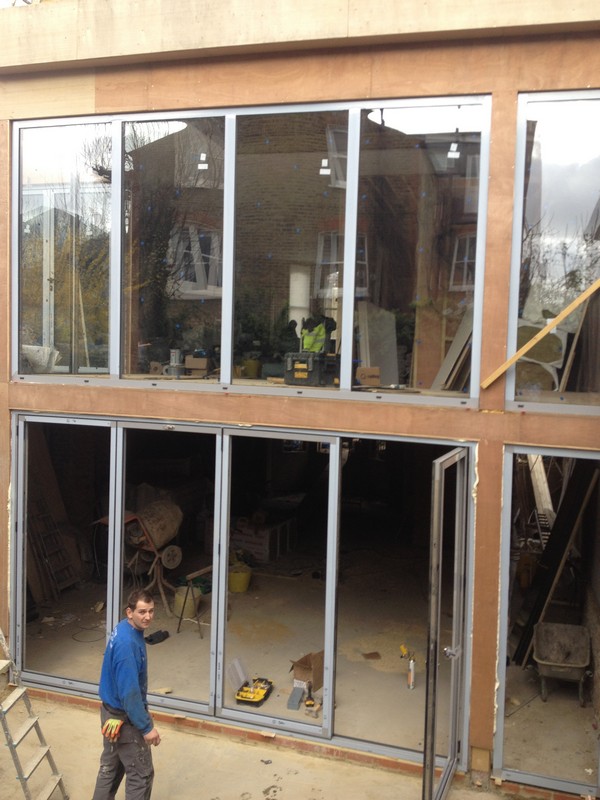 Aluminium bi-fold doors with two-storey glazing in Gerrards Cross