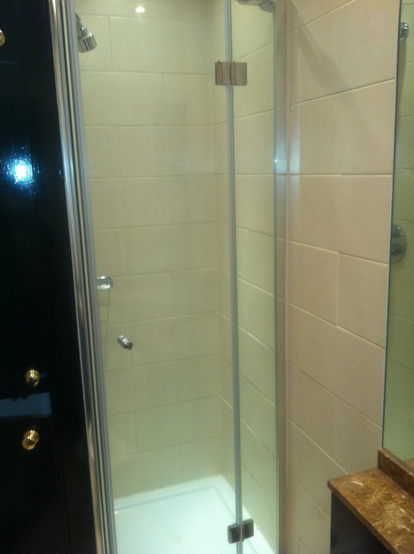 Frameless glass shower enclosure with chrome fittings in Gerrards Cross